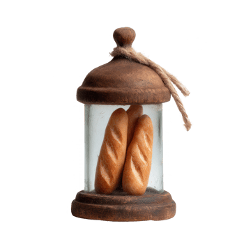 A rustic wooden lantern enclosing two fresh, golden baguettes. The glass structure highlights the rich texture of the bread, perfect for food photography and culinary themes. png