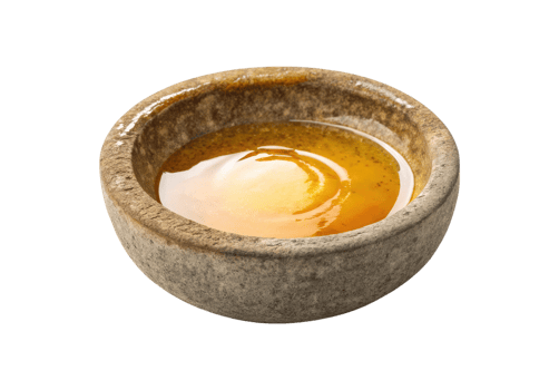 Melted beeswax in a stone bowl isolated on a transparent background png