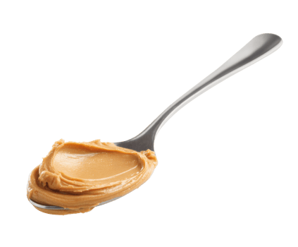 Creamy peanut butter on a spoon ready for a tasty snack or recipe png