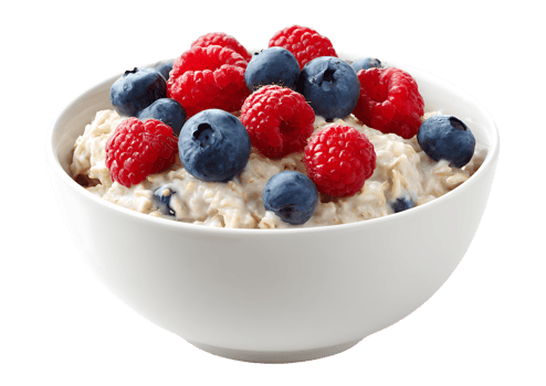 Delicious Oatmeal with Fresh Raspberries and Blueberries in a White Bowl on White png
