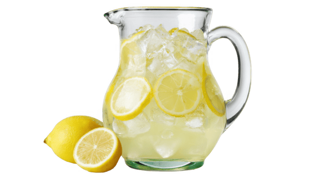Refreshing lemonade in glass pitcher with ice and lemon slices on transparent background png
