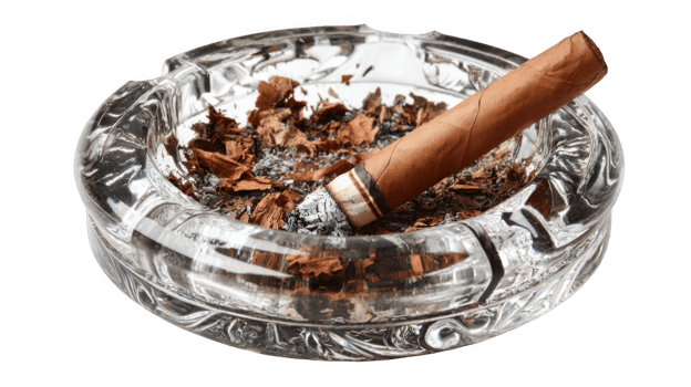 Lit cigar resting on glass ashtray with transparent background png