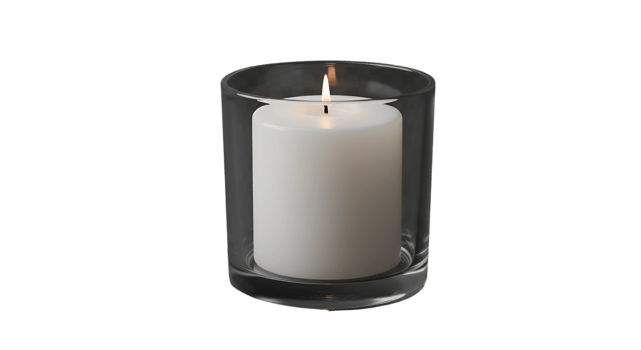 Lit White Pillar Candle in a Smoked Glass Holder with a Visible Flame png