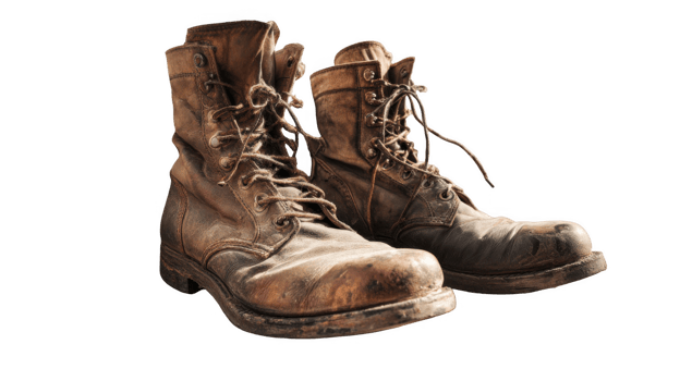 Old leather work boots showing signs of wear and tear on transparent background png