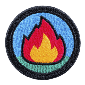 Colorful embroidered patch features stylized flame design, with vibrant red and yellow hues against blue and green background, encircled by black border png