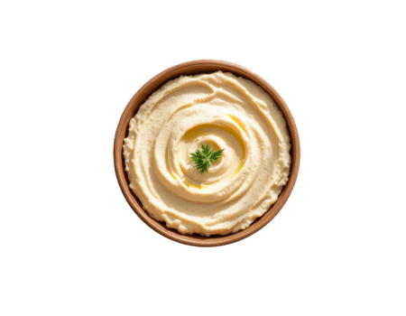Creamy hummus in a brown bowl, garnished with a fresh green sprig png