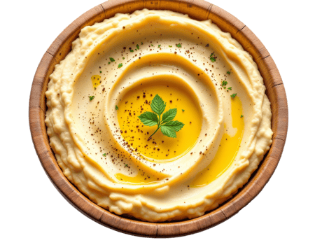A bowl of hummus with a sprig of parsley png