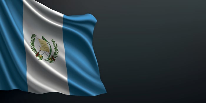Guatemala national flag waving on dark background vector
