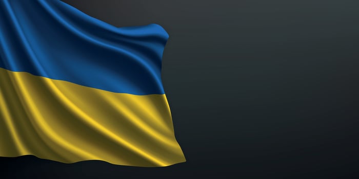 Ukraine national flag waving on dark background vector
