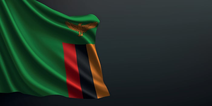 Zambia national flag waving on dark background vector