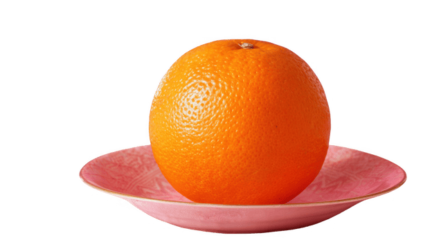 Ripe orange resting on pink plate with transparent background png