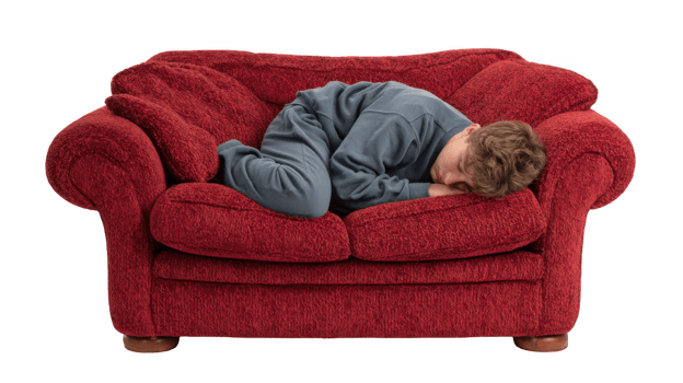 Young boy sleeping peacefully on red sofa with transparent background png