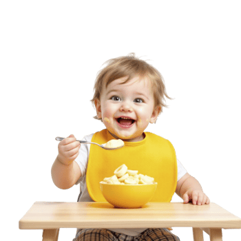 A baby in a yellow bib eating a bowl of cereal png
