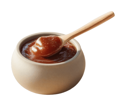 Wooden spoon with brown sauce in round bowl for culinary uses png