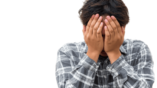 Young man covering face with hands showing despair and shame on transparent background png
