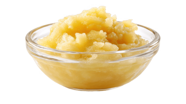 Glass bowl overflowing with delicious golden applesauce on transparent background png