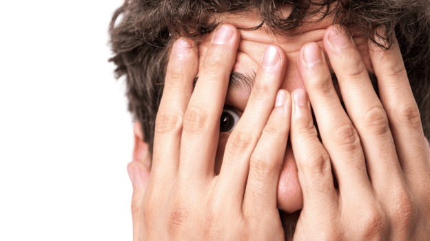Young man hiding face showing anxiety and fear with transparent background png