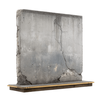Large, weathered concrete slab with visible cracks and signs of aging stands on wooden platform, showcasing rugged and industrial appearance png