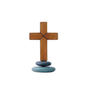 Wooden cross stands balanced on three smooth stones, symbolizing faith and stability. natural textures of wood and stones create serene and contemplative atmosphere png