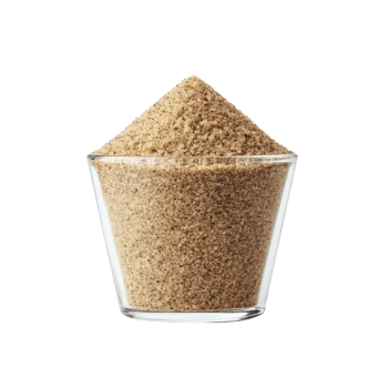 Clear glass filled with brown sugar, showcasing its granular texture and rich color, is set against plain background. sugar is heaped above rim, emphasizing its abundance png