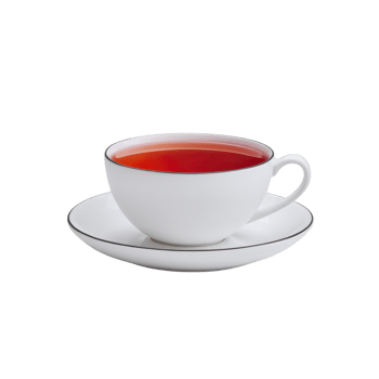 White porcelain teacup filled with vibrant red tea sits elegantly on matching saucer, showcasing minimalist and classic design png