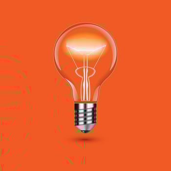 Realistic lit light bulb isolated on orange background. vector