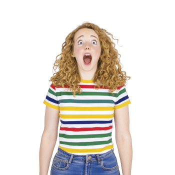 A surprised woman with curly hair wearing colorful striped shirt and jeans stands against plain background, expressing shock or amazement png