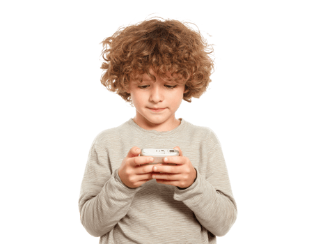 Young boy enjoying a mobile game while standing indoors png