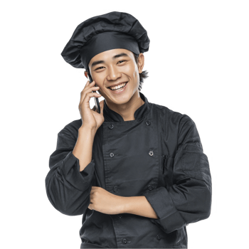 Laughing boy in black chef uniform with cap holding phone isolated on transparent background png