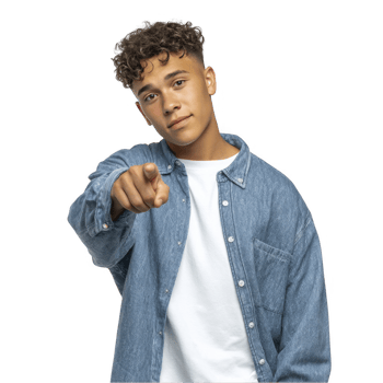 Teen boy in denim shirt pointing confidently with slight smile isolated on transparent background png