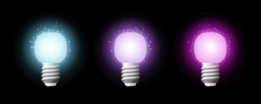 Light bulbs glowing with bright colorful auras on black background vector