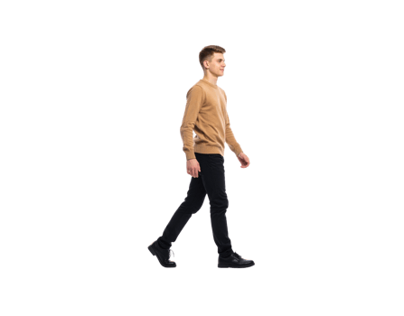 Young Man Walking in Casual Attire Tan Sweater and Black Jeans. png