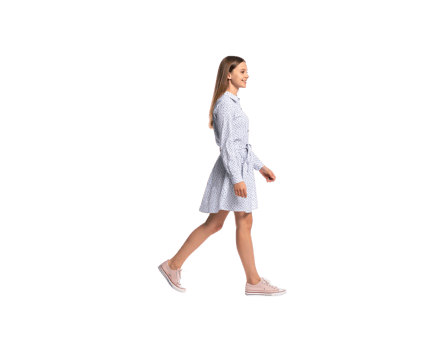 Smiling Woman Walking in a Patterned Dress and Pink Sneakers. png