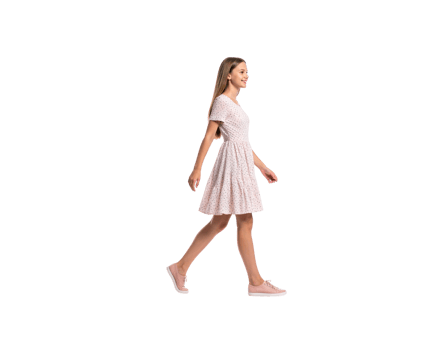 Young Woman Walking in a Polka Dot Dress and Pink Sneakers. png