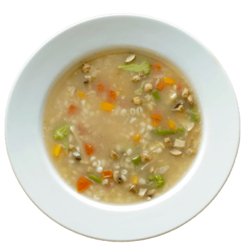 Bowl of vegetable soup with barley on white bowl png