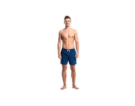 Fit Caucasian man in blue swim trunks standing barefoot smiling slightly. png