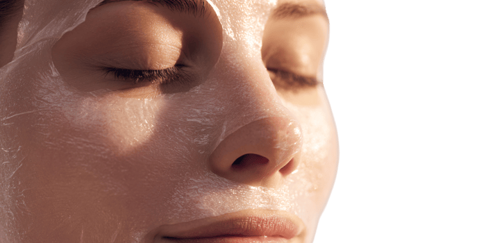 Caucasian woman with closed eyes applying hydrating sheet mask for skincare treatment and wellness routine in the morning sunlight Concept of beauty, selfcare, and rejuvenation png