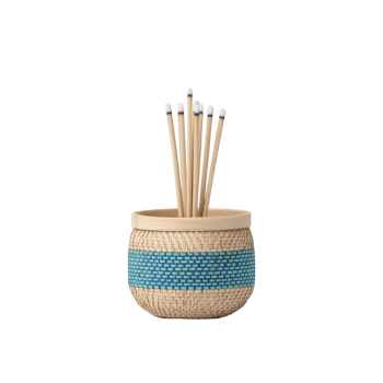 Decorative woven basket with blue accent holds several bamboo sticks with white tips, creating natural and artistic display png