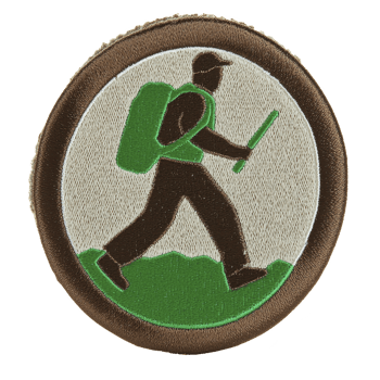 Circular embroidered patch features hiker with backpack and walking stick, set against green and brown background. design is simple and symbolic, representing outdoor activities and adventure png