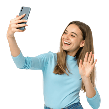 Smiling young woman taking selfie with smartphone, wearing light blue sweater, cheerful expression, waving hand png