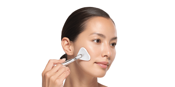 Asian woman using gua sha tool for facial massage at home Concept of skincare, beauty routine, and wellness for healthy glowing skin png