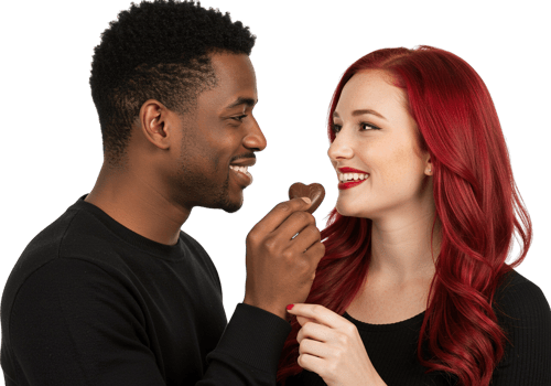A man and woman with red hair are eating chocolate png