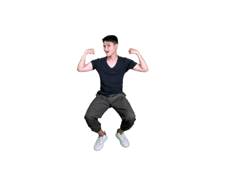 A young man dressed casually poses happily sitting while showing off his arm muscles. png