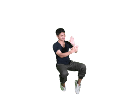Expressive Pose of a Stylish Young Man Sitting in White Studio Setting png