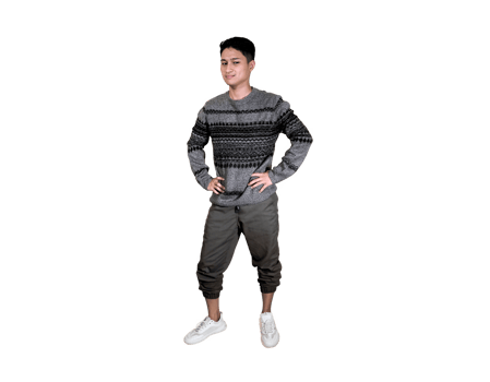 Full-length portrait of a confident young man in a grey patterned sweater standing with arms crossed. png