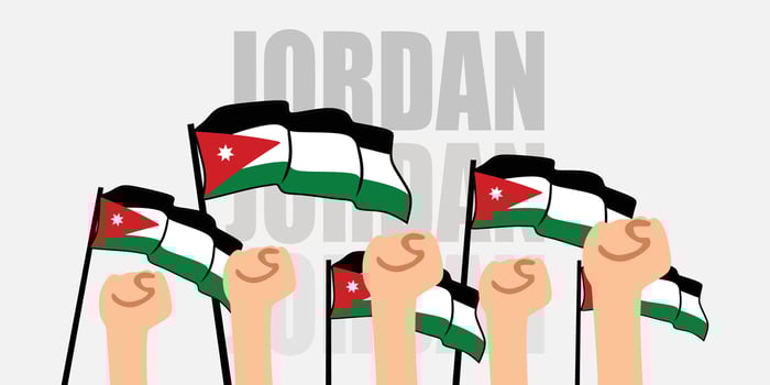 hand with flag of the Jordan or Jordan independence day illustration of Jordan flag with gray background banner or greeting card vector