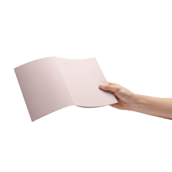 A hand holds open a folded piece of paper possibly a document or brochure for png
