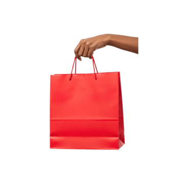 A persons hand is holding a bright red shopping bag against a clean transparent png