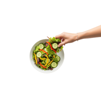 A hand picks a fresh green leaf from a white bowl filled with a colorful salad of png