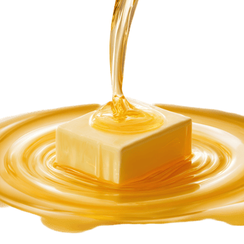 Golden liquid pours onto a cube creating a swirling pool of sweet syrup dessert topping delight png